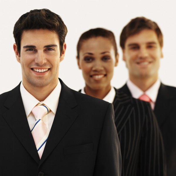 Front view portrait of three business executives smiling