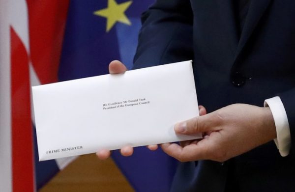 A detail shows EU Council President Donald Tusk who holds British Prime Minister Theresa May's Brexit letter which was delivered by Britain's permanent representative to the European Union Tim Barrow (not pictured) that gives notice of the UK's intention to leave the bloc under Article 50 of the EU's Lisbon Treaty in Brussels, Belgium, March 29, 2017.  REUTERS/Yves Herman