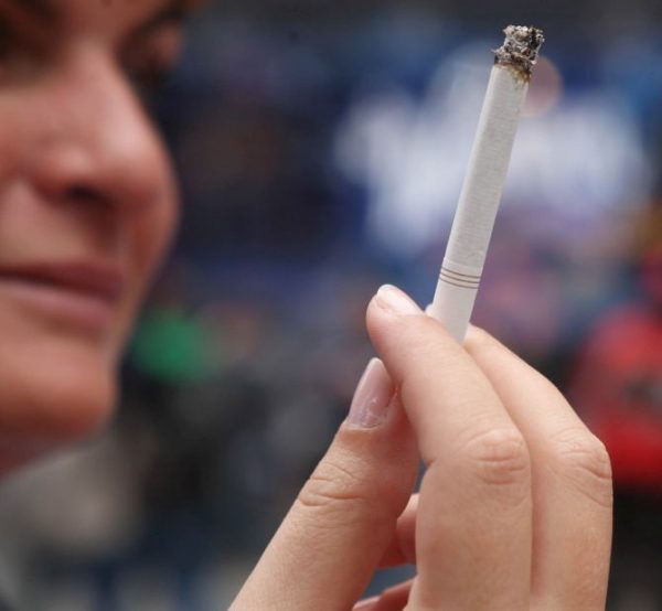 NEW YORK, NY - MAY 23: A woman smokes a cigarette in the pedestrian plaza located in Times Square May 23, 2011 in New York City. A new smoking law took effect in New York City Monday, prohibiting smokers from lighting up in certain public places including parks and beaches. (Photo by Daniel Barry/Getty Images)