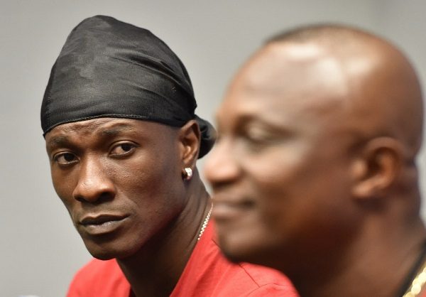 Ghana's forward Asamoah Gyan (L) listens while Head Coach James Kwesi Appiah answers questions during a press conference at Miami Sun Life Stadium in Miami Gardens, Florida on June 8, 2014.  AFP PHOTO MLADEN ANTONOVMLADEN ANTONOV/AFP/Getty Images